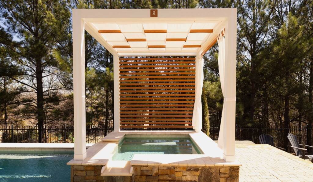 White cabana with wood slat wall over a spa