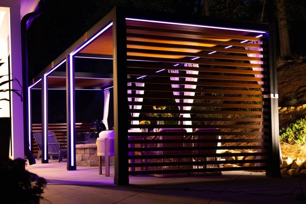 Cabana with purple LED lighting and a slatted wall at night
