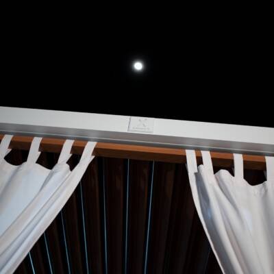 Cabana X curtains tied back under a night sky