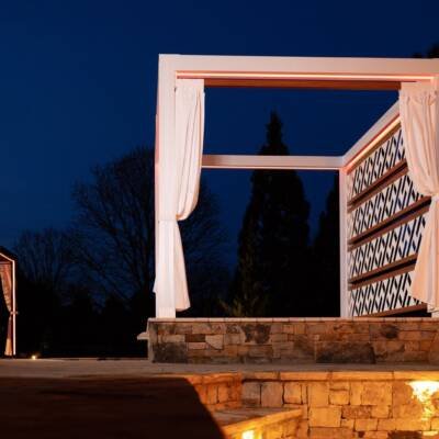 White Cabana X with a lattice privacy wall at night