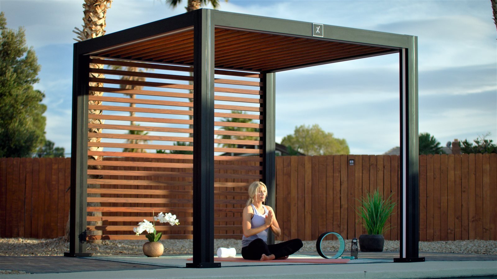 Cabana X with a wood slat privacy wall beside a fence