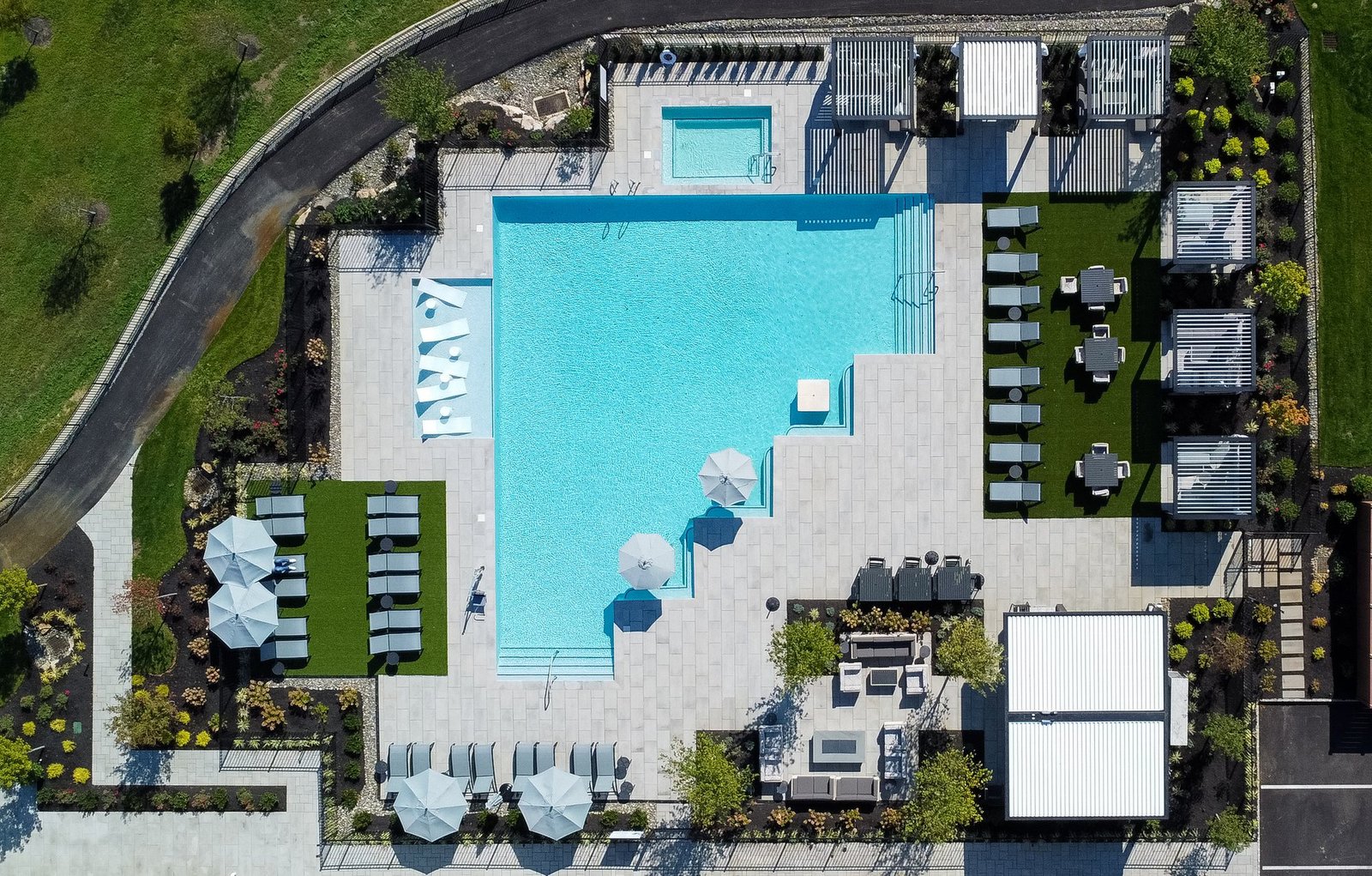 Aerial view of Cabana X cabanas around a community pool deck
