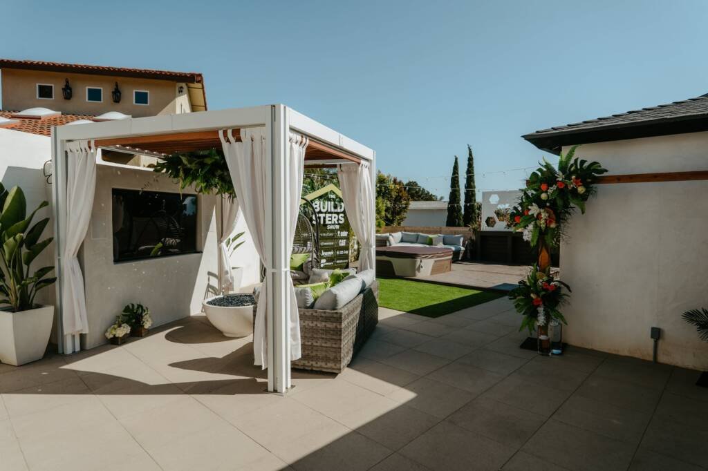 White Cabana X cabanas with curtains in a courtyard