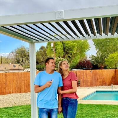 Couple standing under a white Cabana X with white louvers