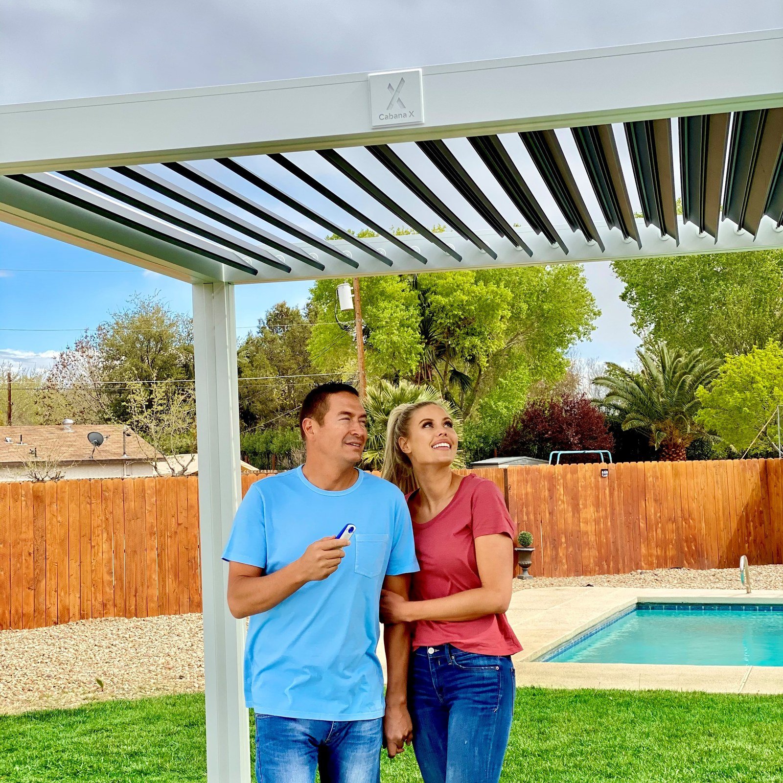 Couple standing under a white Cabana X with white louvers