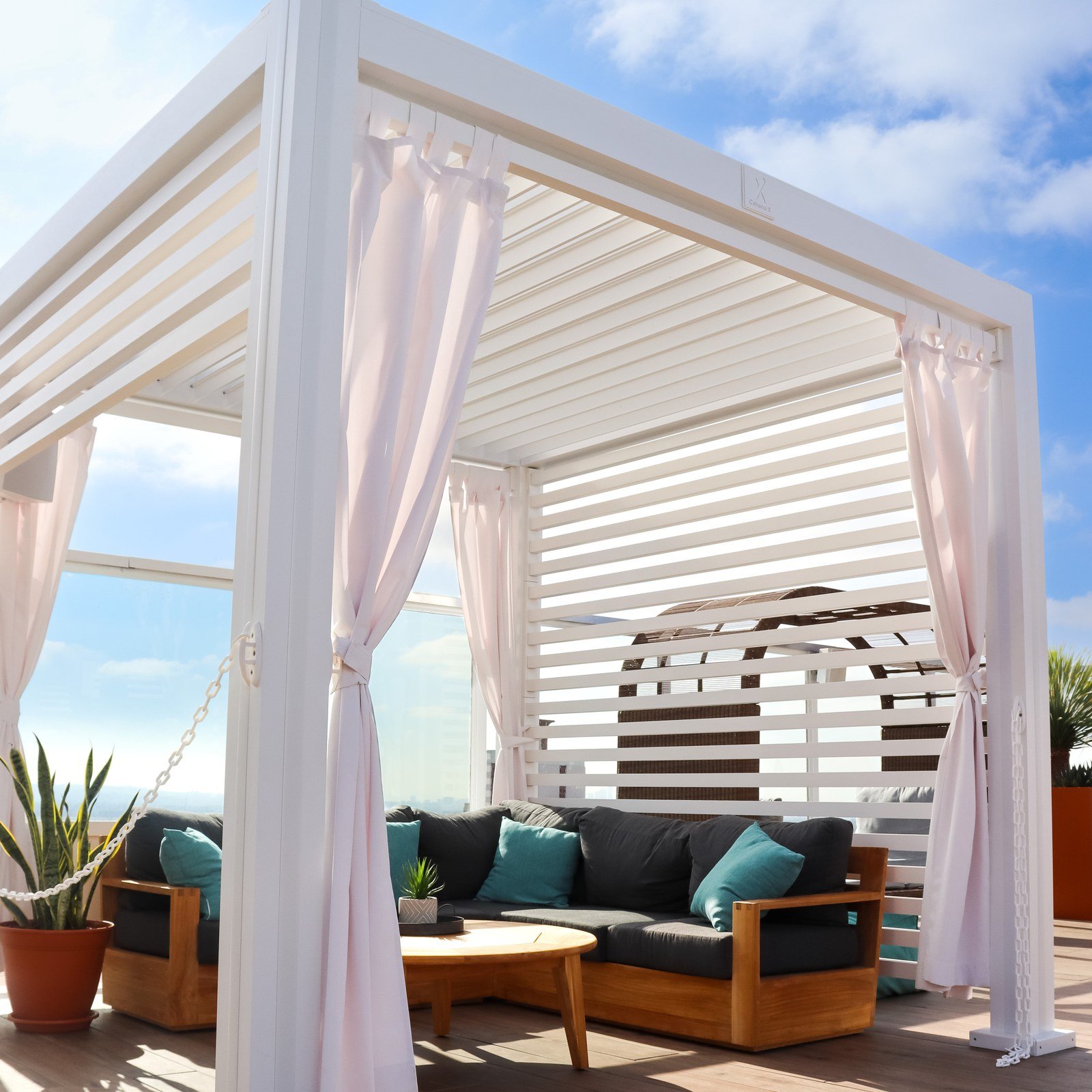 White Cabana X with white louvers on a rooftop terrace